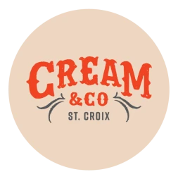The image is a logo featuring the text "CREAM & CO ST. CROIX" in stylized red and gray fonts on a beige circular background.